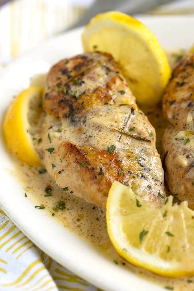 Close up of Creamy Lemon Chicken Breasts on a white plate