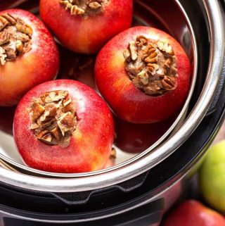 Instant Pot Baked Apples are a delicious sweet treat! These pressure cooker baked apples are flavored with a tasty cinnamon butter, and only take minutes to cook. We love how easy it is to make baked apples in the Instant Pot! simplyhappyfoodie.com #instantpotbakedapples #pressurecookerbakedapples #bakedapples