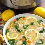 Lemon Chicken Orzo Soup in a white bowl in front of a pressure cooker is a light and delicious soup that you can make in minutes. This pressure cooker lemon chicken orzo soup is a healthy and simple Instant Pot chicken soup. simplyhappyfoodie.com #instantpotchickensoup #instantpotsoup #pressurecookerchickensoup