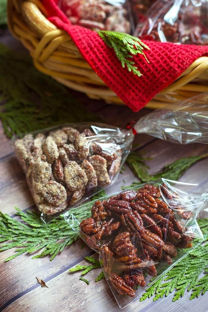  Maple Candied Pecans in small clear bags in front of a wicker basket