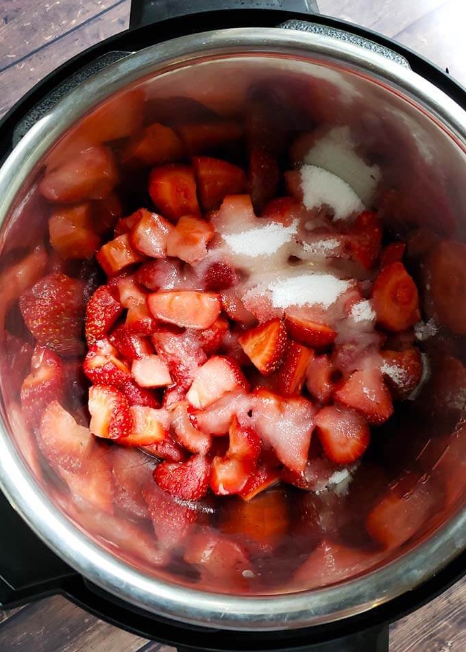Strawberries and sugar in a pressure cooker
