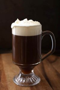 Classic Irish Coffee Recipe in a glass on a wooden board