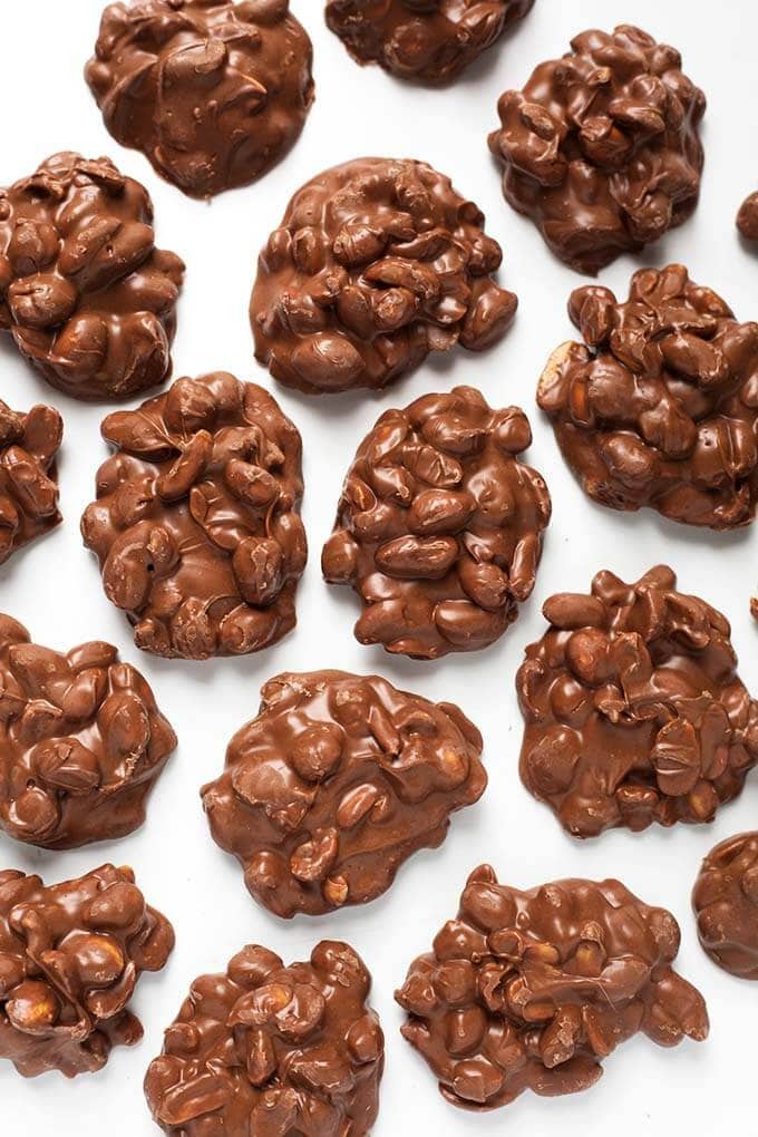 Several Chocolate Peanut Clusters candy on parchment paper