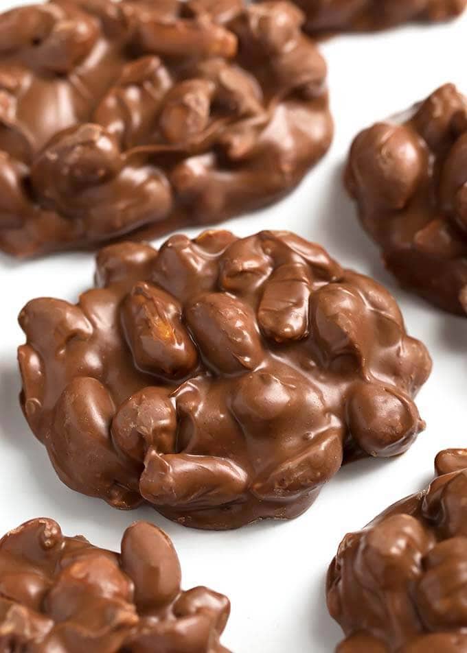 Chocolate Peanut Clusters on parchment paper