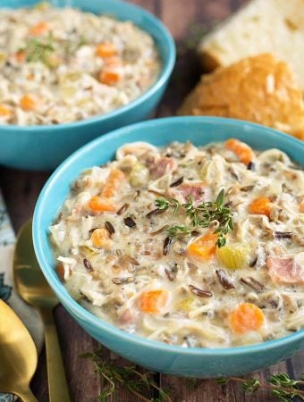 Crock Pot Creamy Chicken Wild Rice Soup is delicious, thick, rich, and so simple to make! Slow cooker creamy chicken wild rice soup is a hearty one pot meal that is perfect for Fall. My whole family loves this soup! simplyhappyfoodie.com #wildricesoup #crockpotchickenwildricesoup #slowcookerwildricesoup