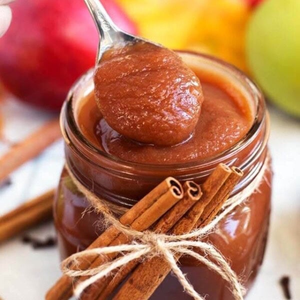 Instant Pot Apple Butter in a jar with a spoonful.