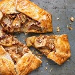 Apple Galette on a baking sheet with a slice slightly removed