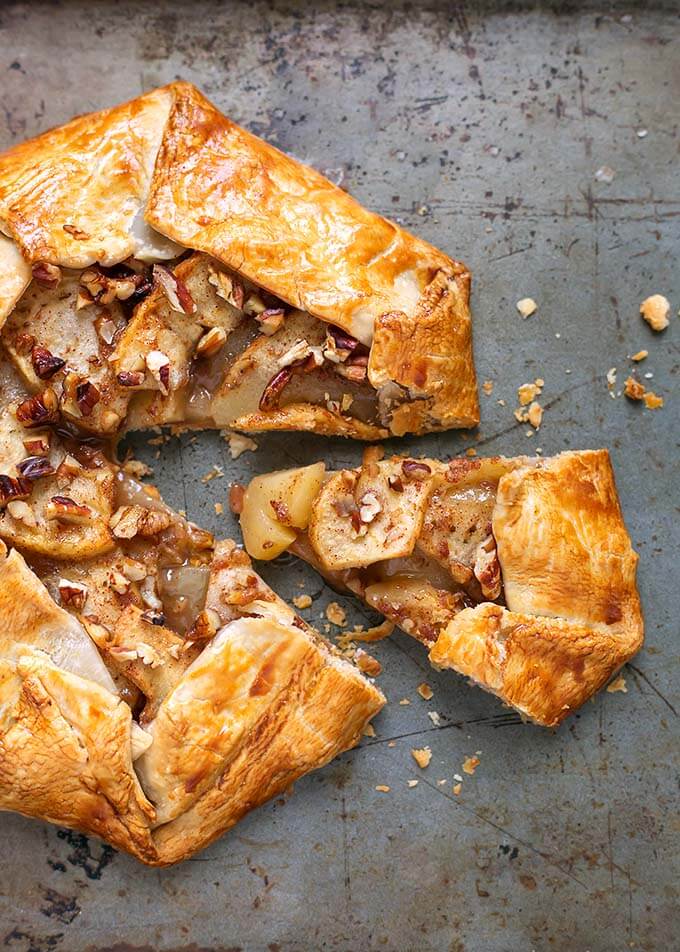 Apple Galette on a baking sheet with a slice slightly removed