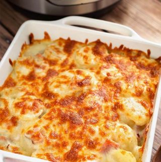 Instant Pot Scalloped Potatoes have a delicious flavor, especially when you use a smoky ham and some nice cheese for extra creaminess. These pressure cooker scalloped potatoes cook much faster than in the oven, and are my family's favorite Easter side dish, as well as Thanksgiving side dish! Instant Pot recipes by simplyhappyfoodie.com #instantpotscallopedpotatoes #pressurecookerscallopedpotatoes