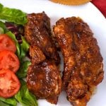 Two Country Style Ribs on a white plate with vegetables