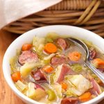 Instant Pot Kielbasa Cabbage Potato Soup is a Fall soup if ever there was one! This simple and rustic soup has a rich broth and chunky carrots, green cabbage, and tasty smoked kielbasa. This pressure cooker Kielbasa Cabbage Potato Soup recipe is one of my family's favorites! simplyhappyfoodie.com #instantpotrecipes #instantpotsoup #instantpotcabbagepotatosoup #pressurecookersoup