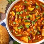 Instant Pot Minestrone Soup is a classic Italian soup loaded with vegetables, beans, pasta, and lots of flavor! When you make this pressure cooker minestrone soup, clean out that vegetable drawer in the fridge! This is a versatile and tasty Instant Pot soup recipe! Instant Pot Recipes by simplyhappyfoodie.com #instantpotminestronesoup #instantpotsoup #pressurecookerminestrone #pressurecookersouprecipe