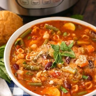 Instant Pot Minestrone Soup is a classic Italian soup loaded with vegetables, beans, pasta, and lots of flavor! When you make this pressure cooker minestrone soup, clean out that vegetable drawer in the fridge! This is a versatile and tasty Instant Pot soup recipe! Instant Pot Recipes by simplyhappyfoodie.com #instantpotminestronesoup #instantpotsoup #pressurecookerminestrone #pressurecookersouprecipe