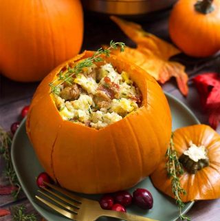 Instant Pot Stuffed Pumpkin is so delicious! This is a Fall recipe that can be a main dish or a side dish. A pumpkin stuffed with a savory and creamy stuffing that you can change up to make it your own! This pressure cooker stuffed pumpkin is as beautiful as it is scrumptious! Instant Pot recipes by simplyhappyfoodie.com #instantpotstuffedpumpkin #instantpotpumpkin #instantpotthanksgiving #pressurecookerpumpkin