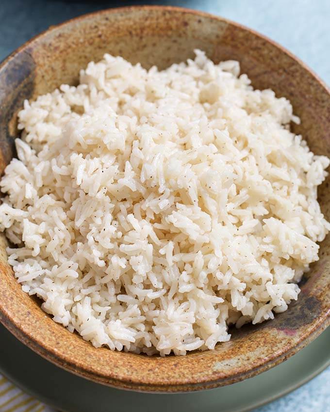 Closeup of White Rice in a brown stoneware bowl