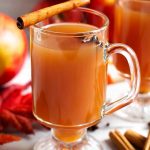 Spiced Apple Hot Toddy in a glass with a handle topped with a cinnamon stick and anise seed