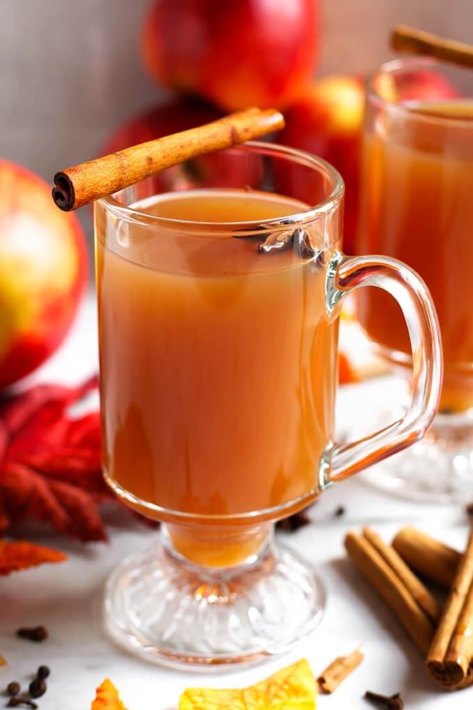 Spiced Apple Hot Toddy in a glass with a handle topped with a cinnamon stick and anise seed