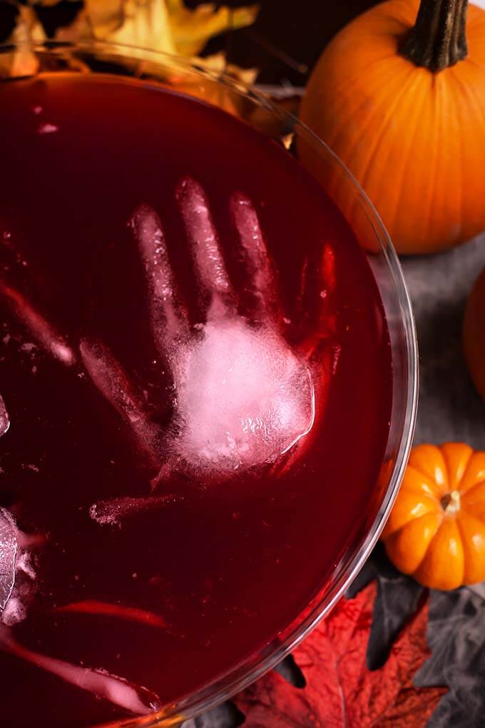 Closeup of ice hand floating in Spooky Halloween Party Punch in a glass punch bowl