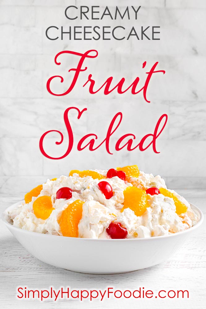 Creamy Cheesecake Fruit Salad is deliciously creamy, and not too sweet. This is a very easy fruit salad to make, with fruit cocktail and other tasty ingredients! This is our favorite Holiday and special occasion fruit salad recipe. simplyhappyfoodie.com #fruitsaladrecipe #cheesecakefruitsalad