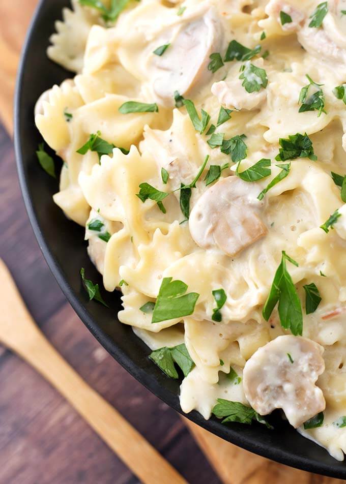 Closeup of Leftover Turkey Pasta on a black plate next to a wooden fork