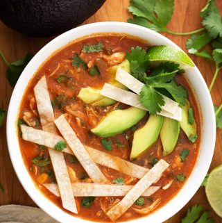 Instant Pot Chicken Tortilla Soup is a very flavorful Mexican soup. If you haven't had a tortilla soup before, the spices, herbs, and corn tortillas give this Pressure Cooker Chicken Tortilla soup a wonderful fiesta of flavor! Instant Pot recipes by simplyhappyfoodie.com #instantpotchickentortillasoup #instantpotsouprecipes