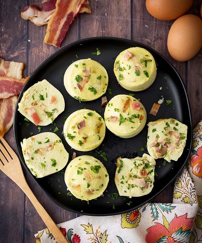 Top view of several Egg Bites on a black plate