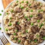 Instant Pot Mushroom Risotto with Peas is creamy, delicious, and super easy to make. This risotto is good with or without the peas. If you don't like them, just leave them out. Pressure cooker mushroom risotto with peas is one of my favorite Instant Pot recipes! simplyhappyfoodie.com #instantpotrisotto #pressurecookerrisotto