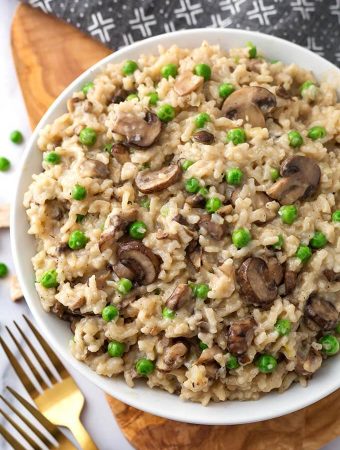 Instant Pot Mushroom Risotto with Peas is creamy, delicious, and super easy to make. This risotto is good with or without the peas. If you don't like them, just leave them out. Pressure cooker mushroom risotto with peas is one of my favorite Instant Pot recipes! simplyhappyfoodie.com #instantpotrisotto #pressurecookerrisotto