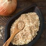 Homemade Onion Soup Mix in a dark wooden leaf-shaped bowl with a wooden spoon