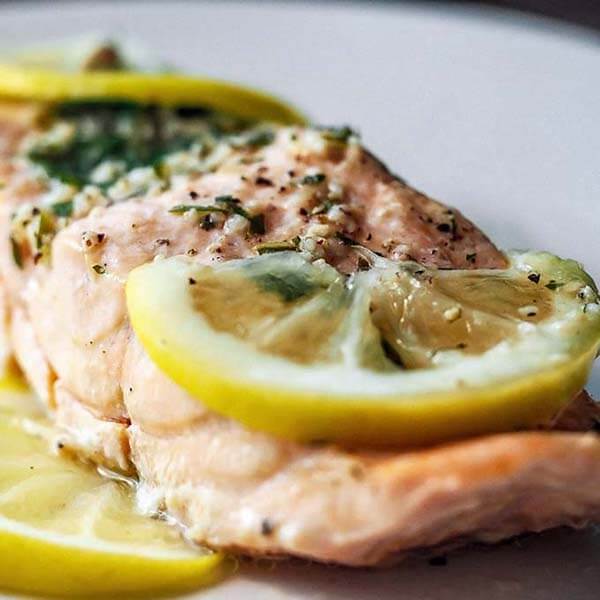 close up of salmon with lemon slices