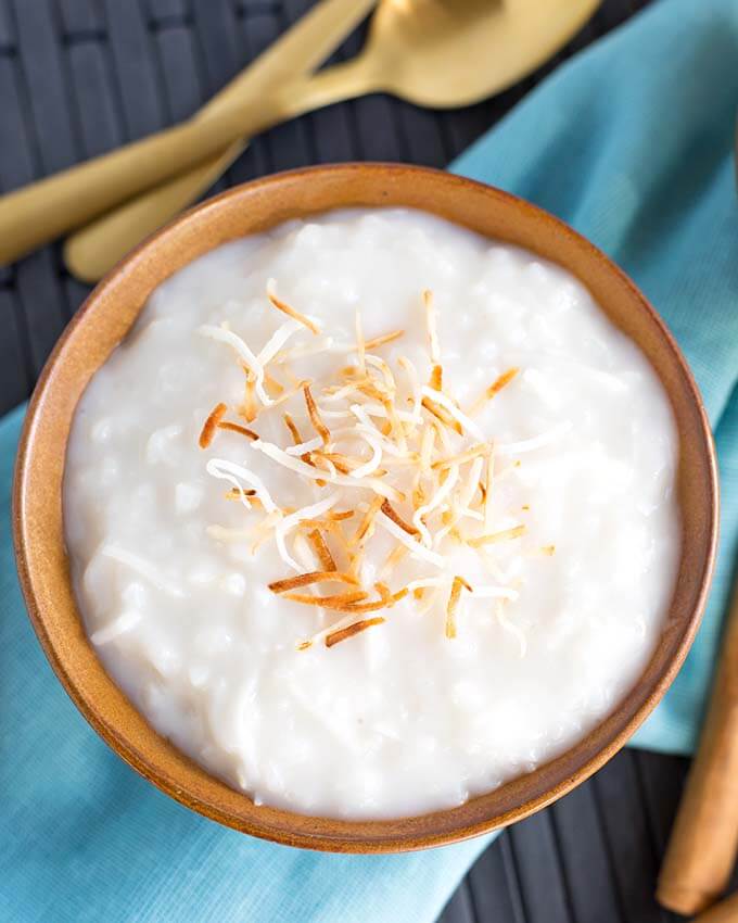 Coconut Rice Pudding in a brown bowl topped with toasted coconut