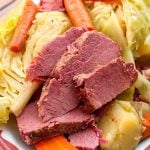 Corned Beef and Cabbage on a white plate with red boarder