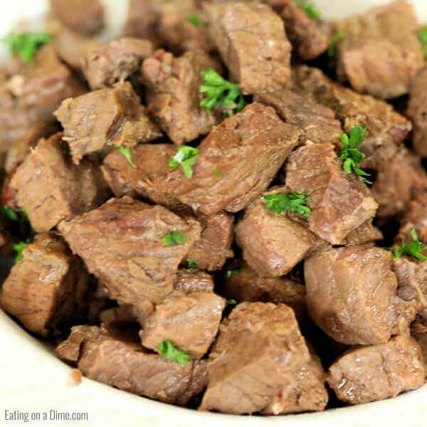 steak bites in a white bowl with eating on a dime logo