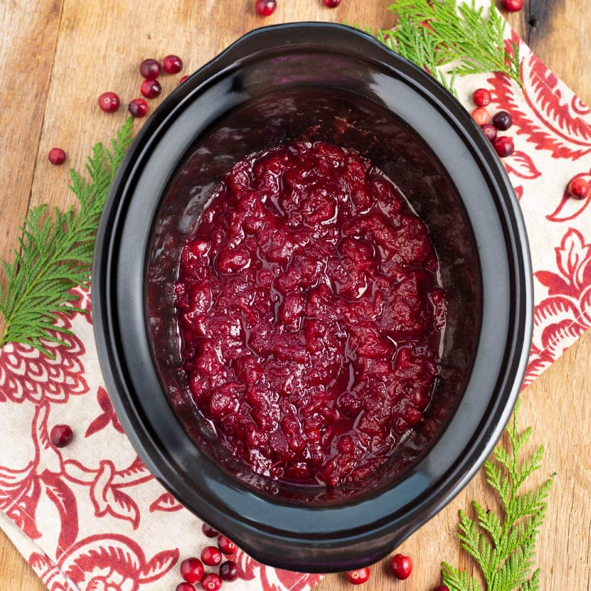 Slow Cooker Cranberry Sauce in a black crock