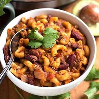 chili mac with a silver spoon in a white bowl