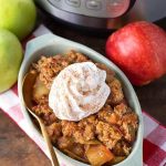 Apple Crisp in small baking dish in front of pressure cooker