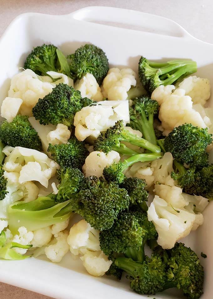 broccoli and cauliflower in a white baking dish