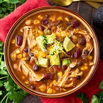 Instant Pot Chicken Taco Soup in a brown bowl on top of a red napkin