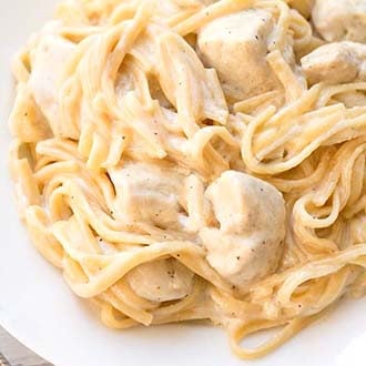instant pot fettuccine alfredo with chicken on a white plate