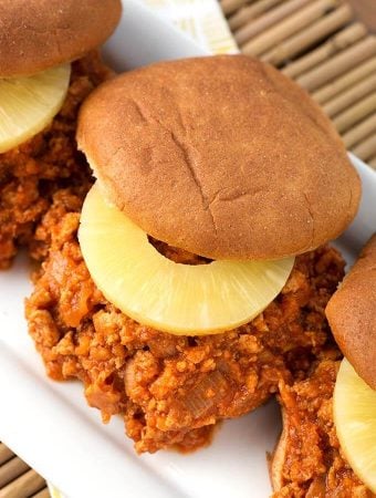 Hawaiian BBQ Sloppy Joes with slice of pineapple on a hamburger bun