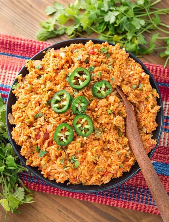 Mexican Rice in a black bowl with wooden spoon