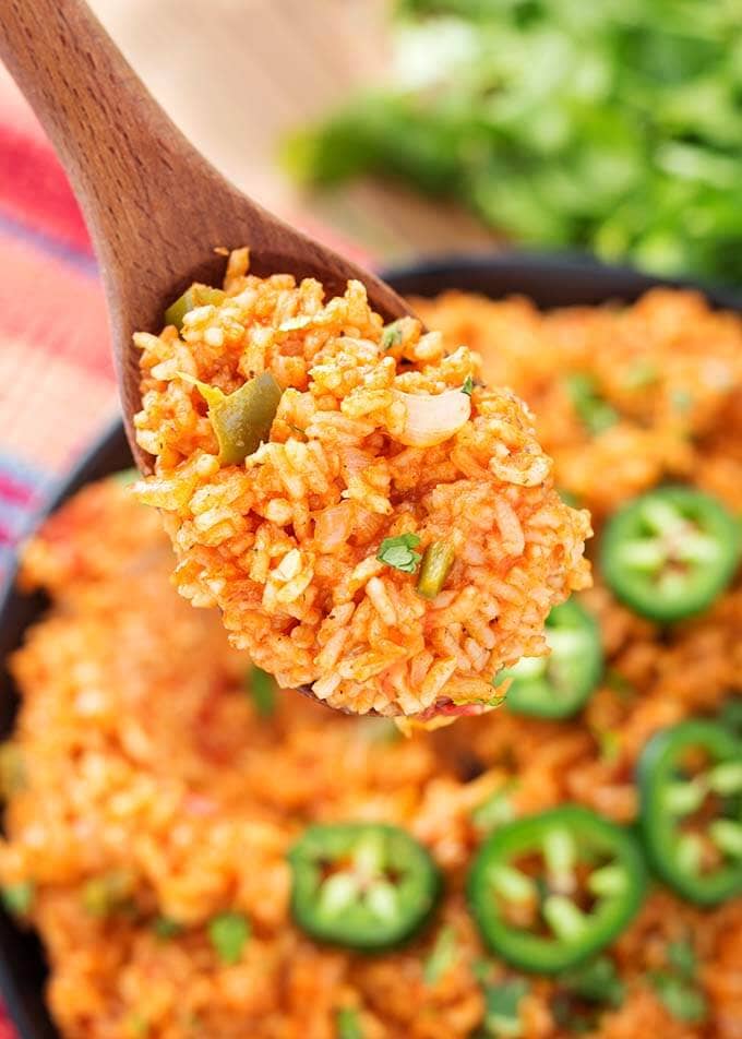 Closeup wooden spoon full of Mexican Rice