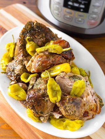 Mississippi Pork on a white platter on a wooden board