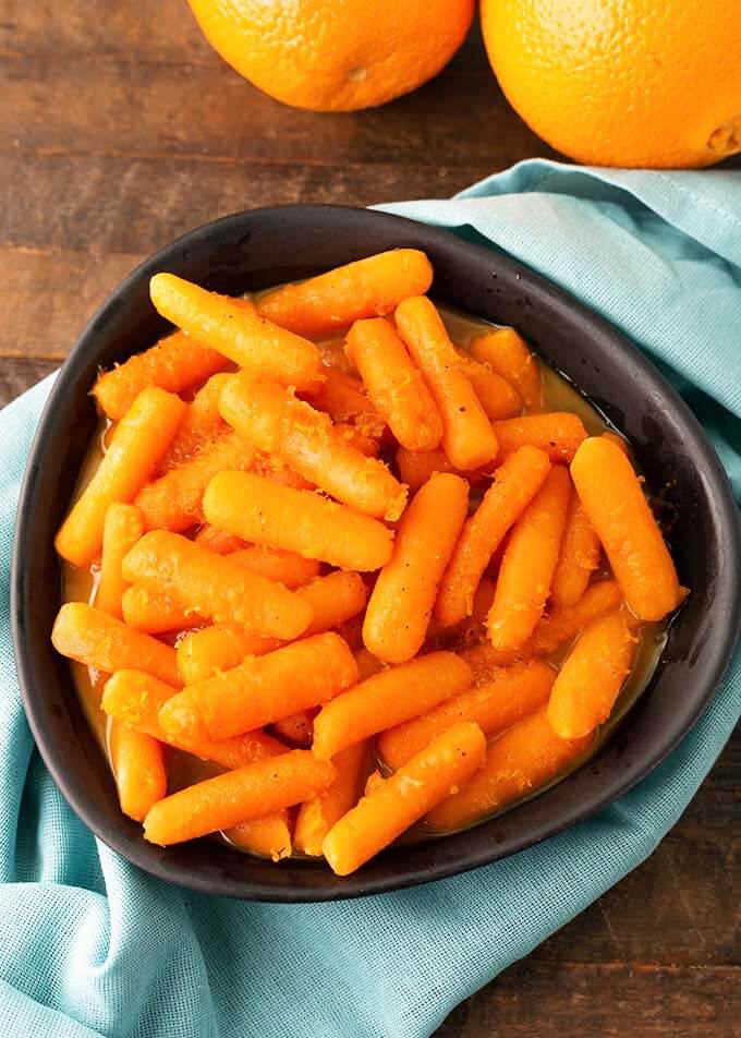 Orange Maple Carrots in black bowl on light blue napkin