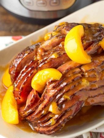 Peach Glazed Ham on white serving platter