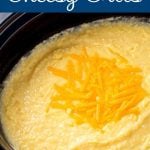 Slow Cooker Cheesy Grits in a black crock