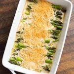 Creamy Baked Asparagus Alfredo in white baking dish on wooden surface