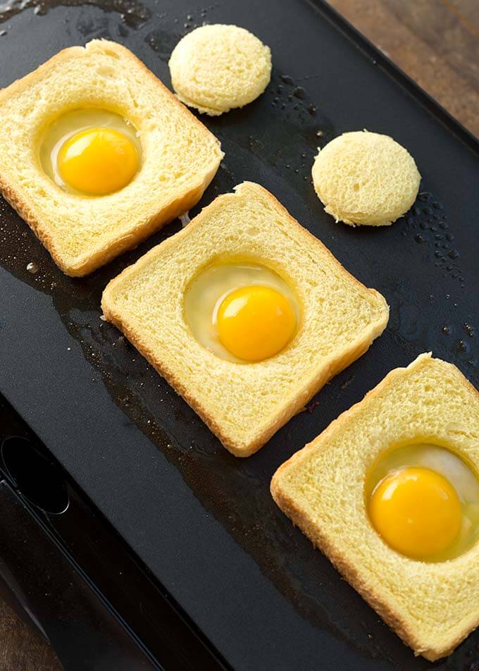 Uncooked Egg in a Holes on a griddle