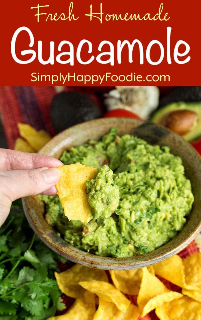 Hand dipping corn tortilla chip into Fresh Homemade Guacamole with title and Simply Happy Foodie.com logo