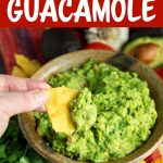 Fresh Homemade Guacamole on a chip in hand